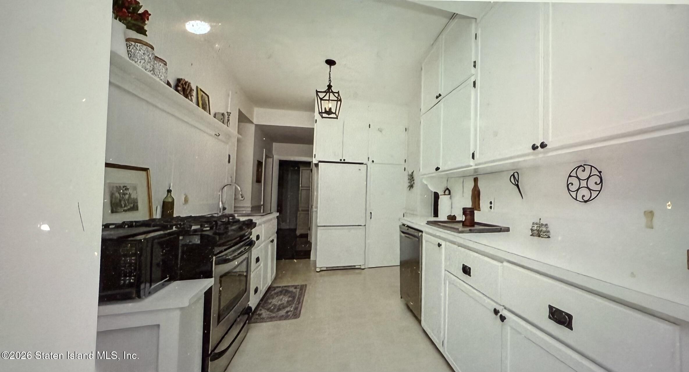 111 David Street Staten Island, NY 10308 - Photo 13 of 38 a kitchen with stainless steel appliances a sink stove and refrigerator