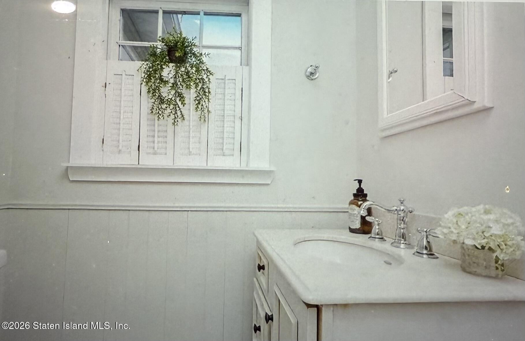 111 David Street Staten Island, NY 10308 - Photo 20 of 38 a bathroom with a sink and a mirror
