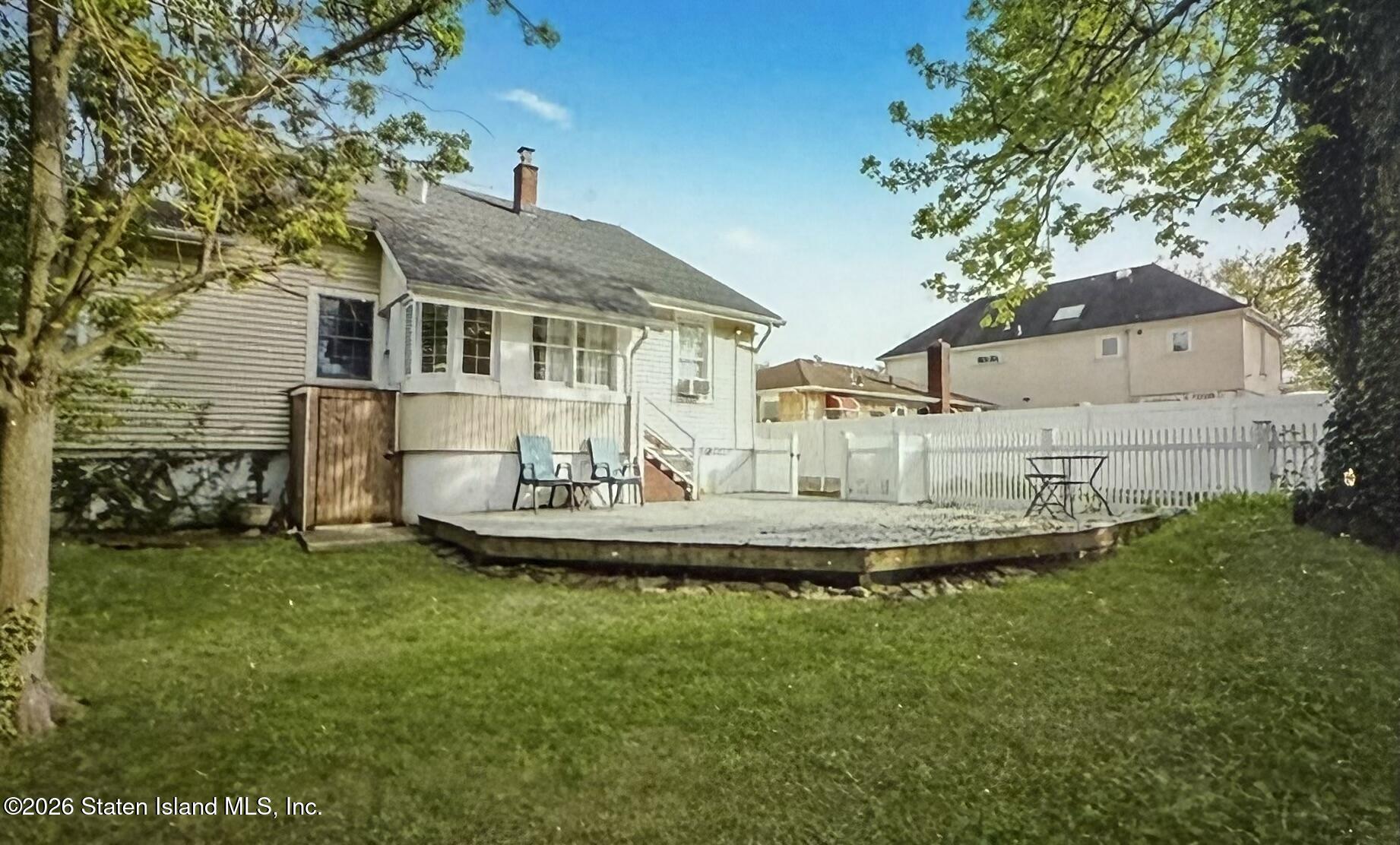 111 David Street Staten Island, NY 10308 - Photo 32 of 38 a front view of a house with a garden and plants