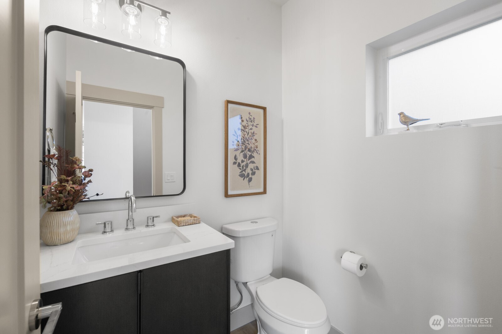 2931 39th Avenue Southwest Seattle, WA 98116 - Photo 12 of 40 a bathroom with a toilet a sink a mirror and a window