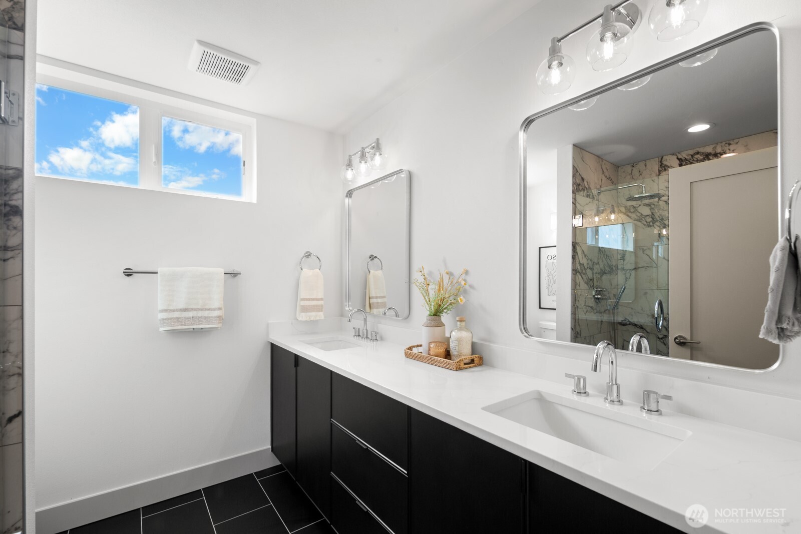 2931 39th Avenue Southwest Seattle, WA 98116 - Photo 16 of 40 a bathroom with a sink double vanity and a mirror