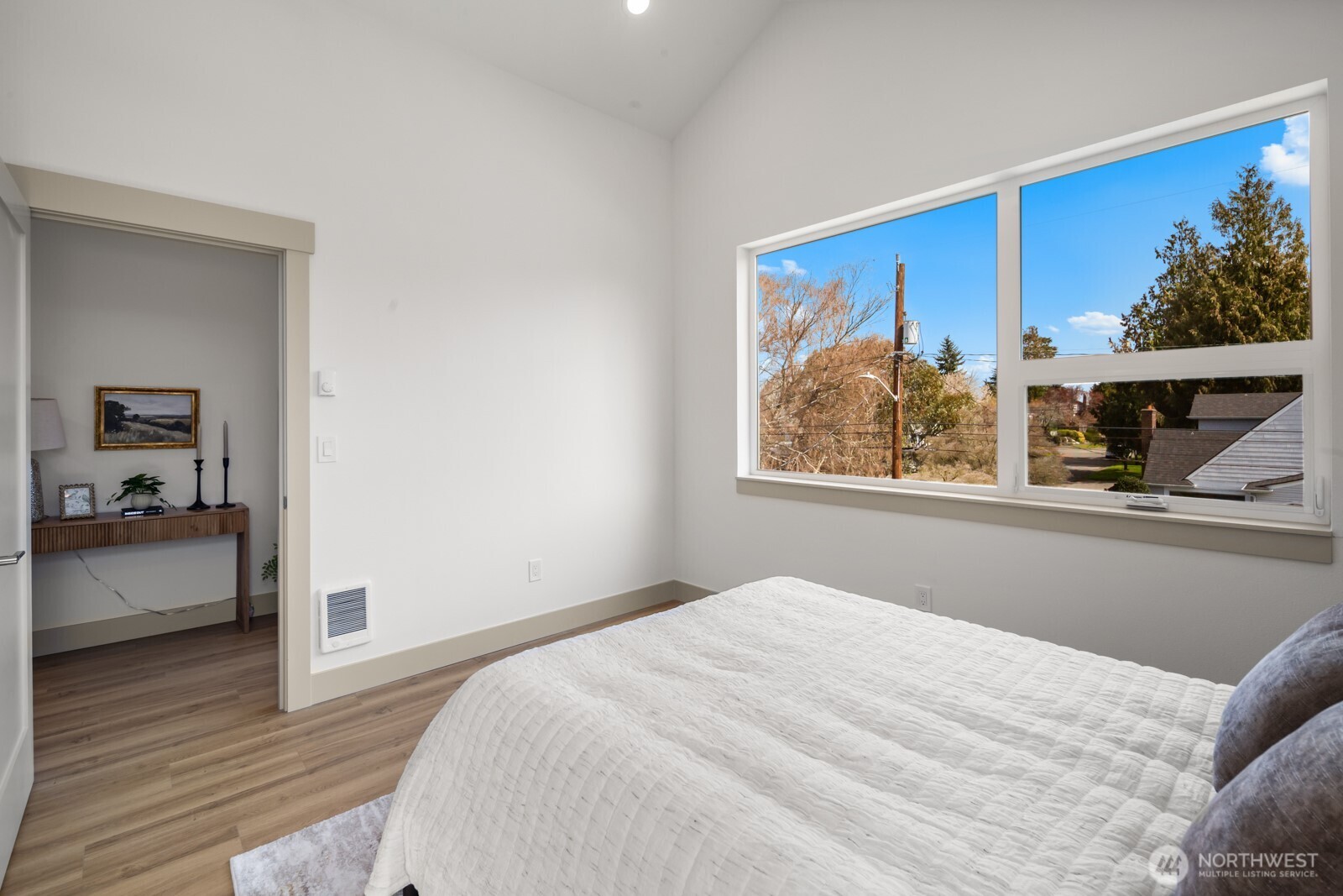 2931 39th Avenue Southwest Seattle, WA 98116 - Photo 21 of 40 a bedroom with a large bed and a painting on the wall