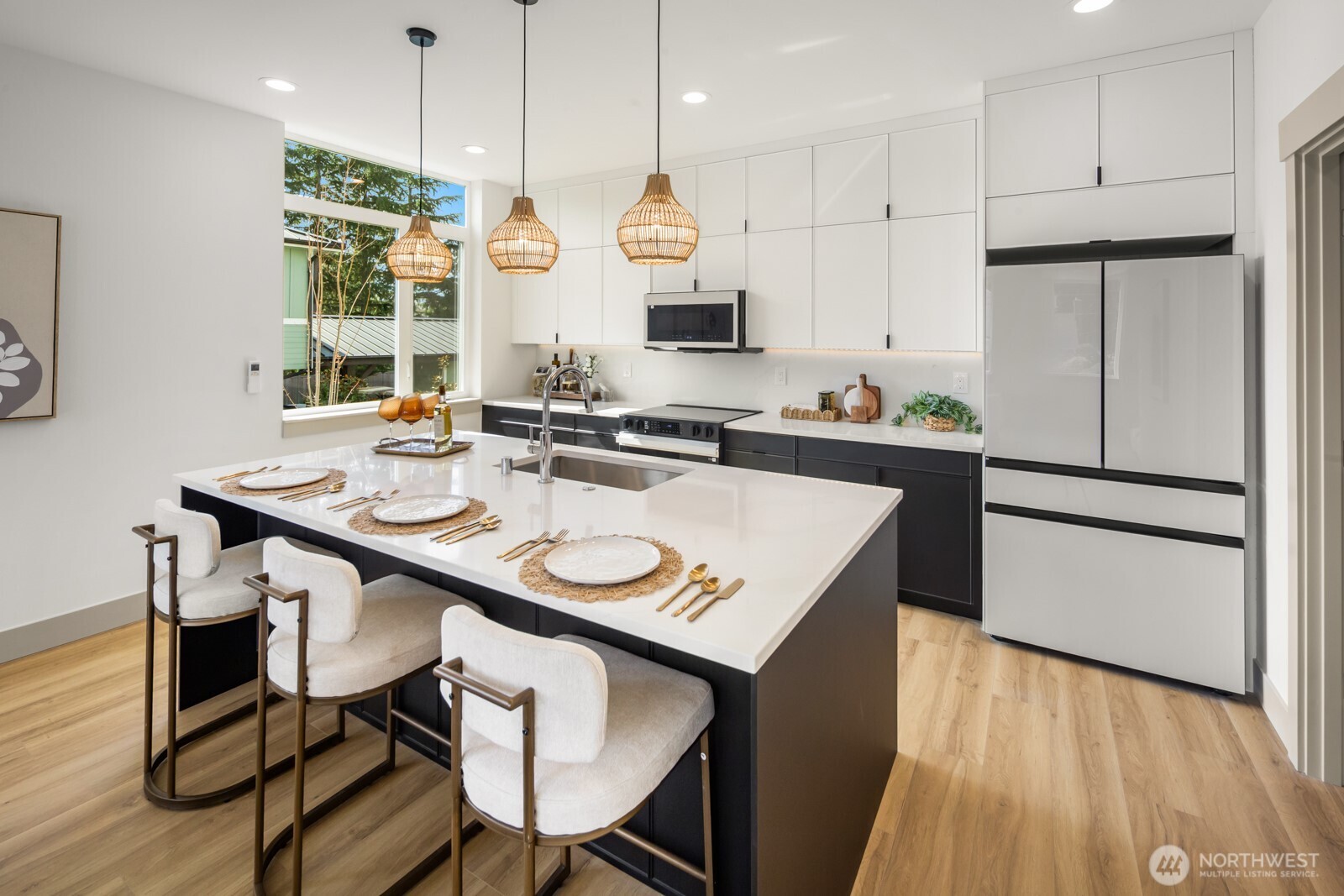2931 39th Avenue Southwest Seattle, WA 98116 - Photo 6 of 40 a kitchen with stainless steel appliances granite countertop a sink a stove a refrigerator and island with wooden floor