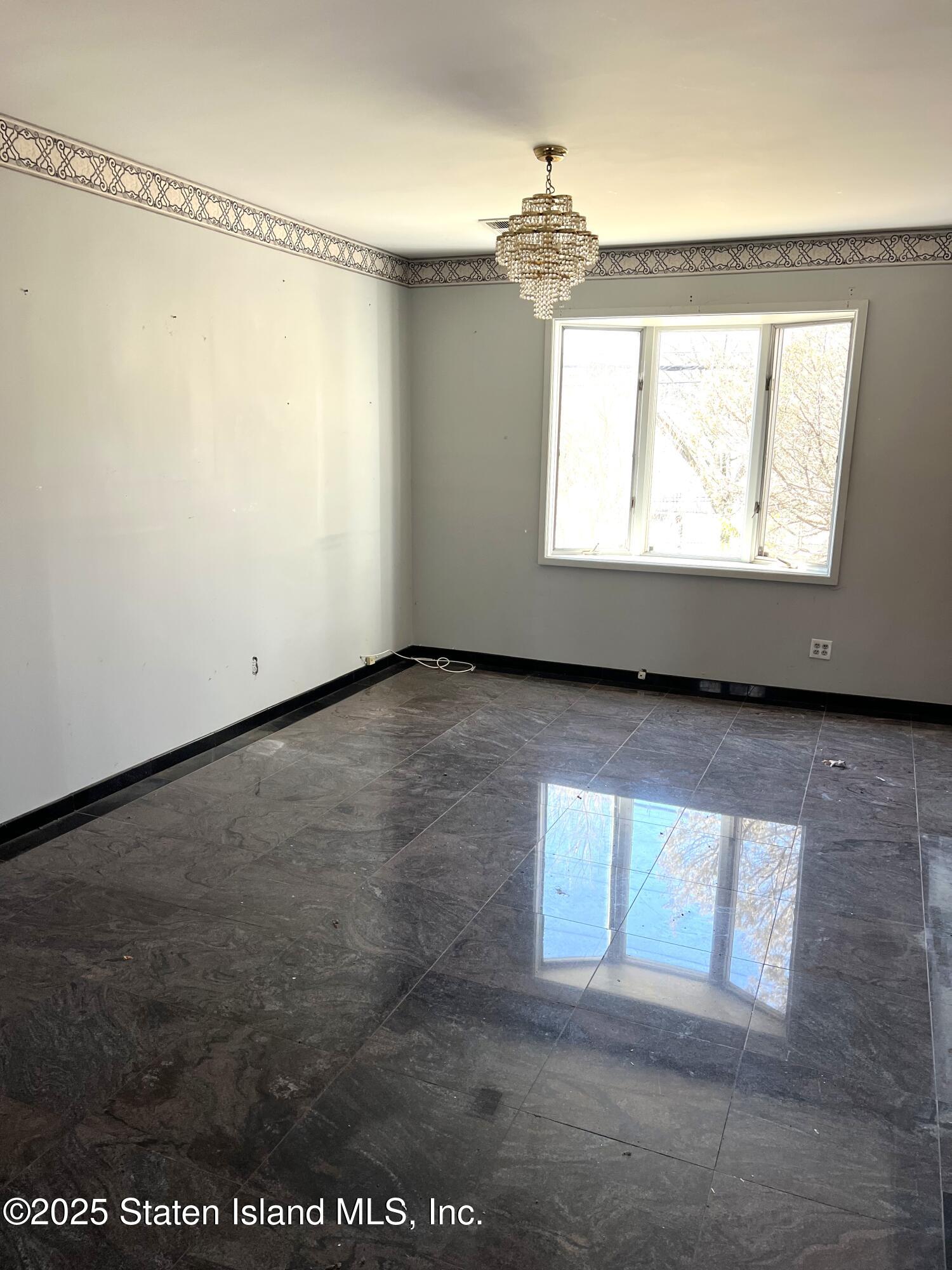 85 Foster Road Staten Island, NY 10309 - Photo 12 of 34 a view of an empty room and window