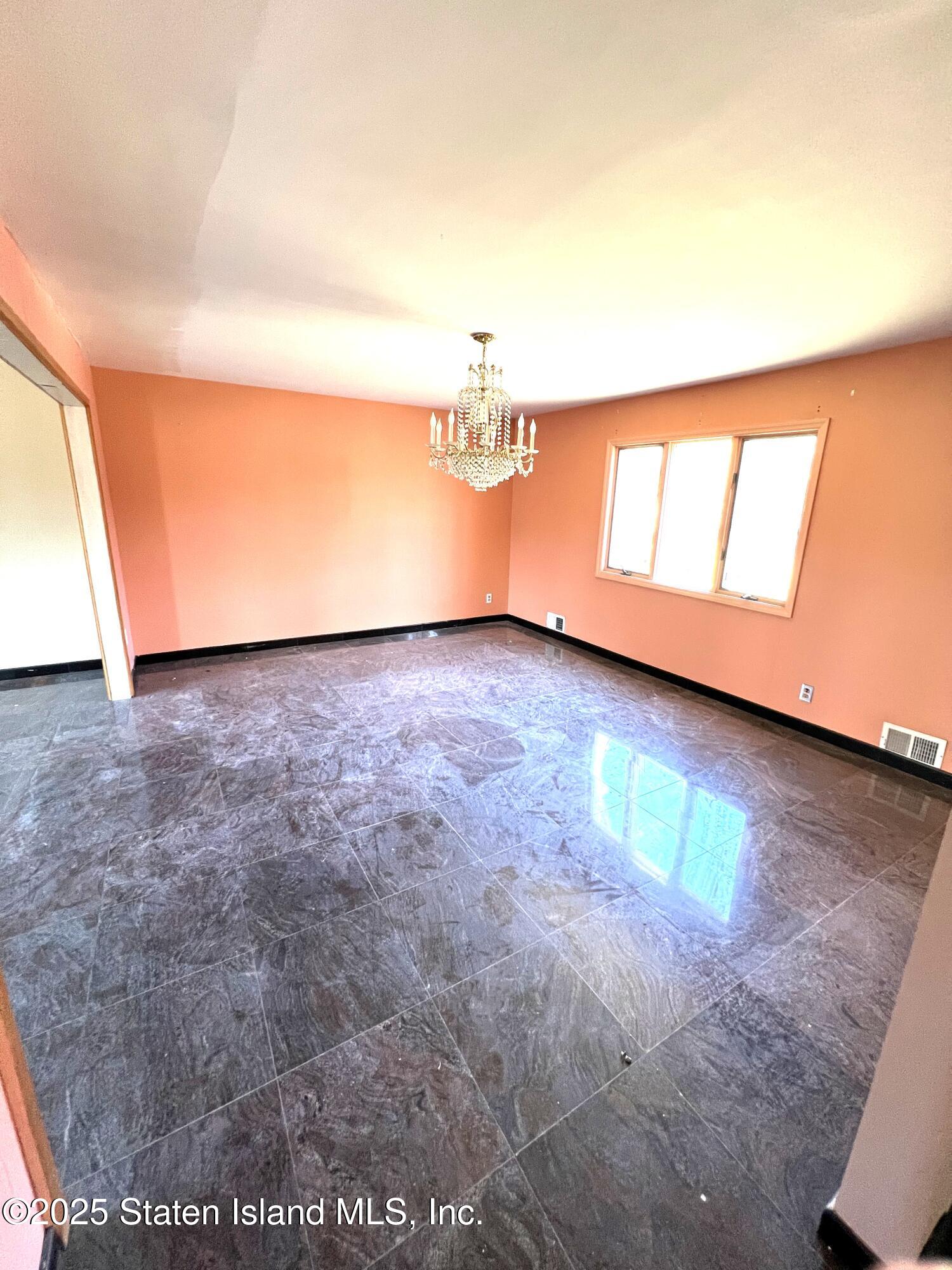 85 Foster Road Staten Island, NY 10309 - Photo 16 of 34 wooden floor in an empty room with a window