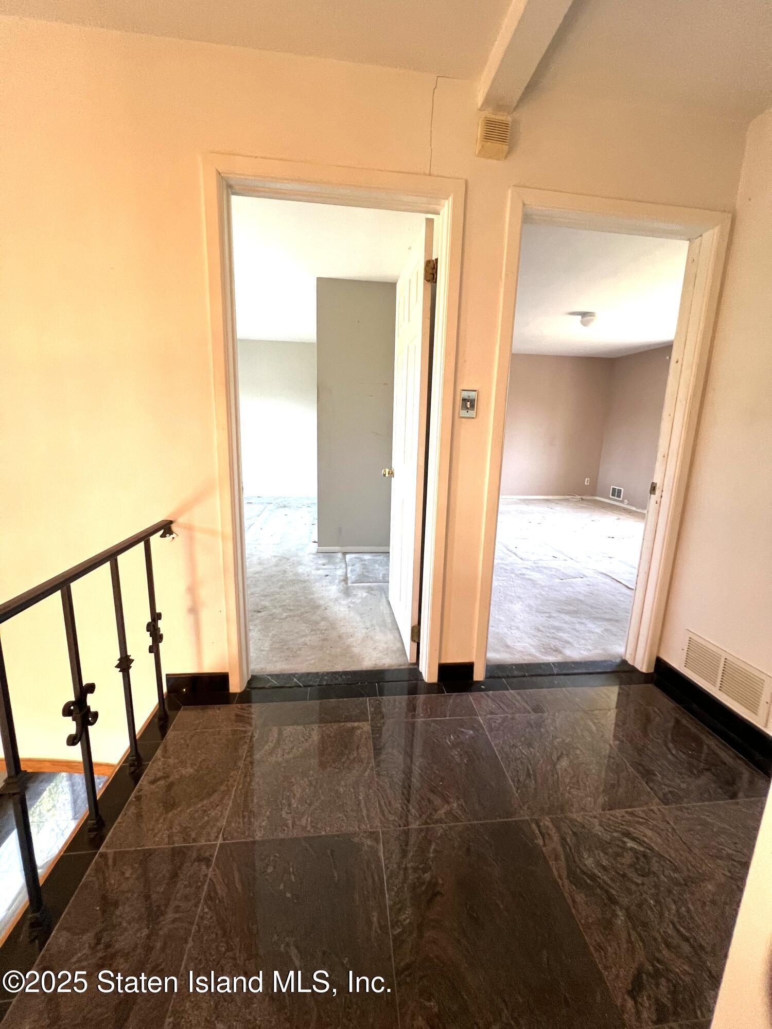 85 Foster Road Staten Island, NY 10309 - Photo 18 of 34 hallway view with wooden floor and stairs