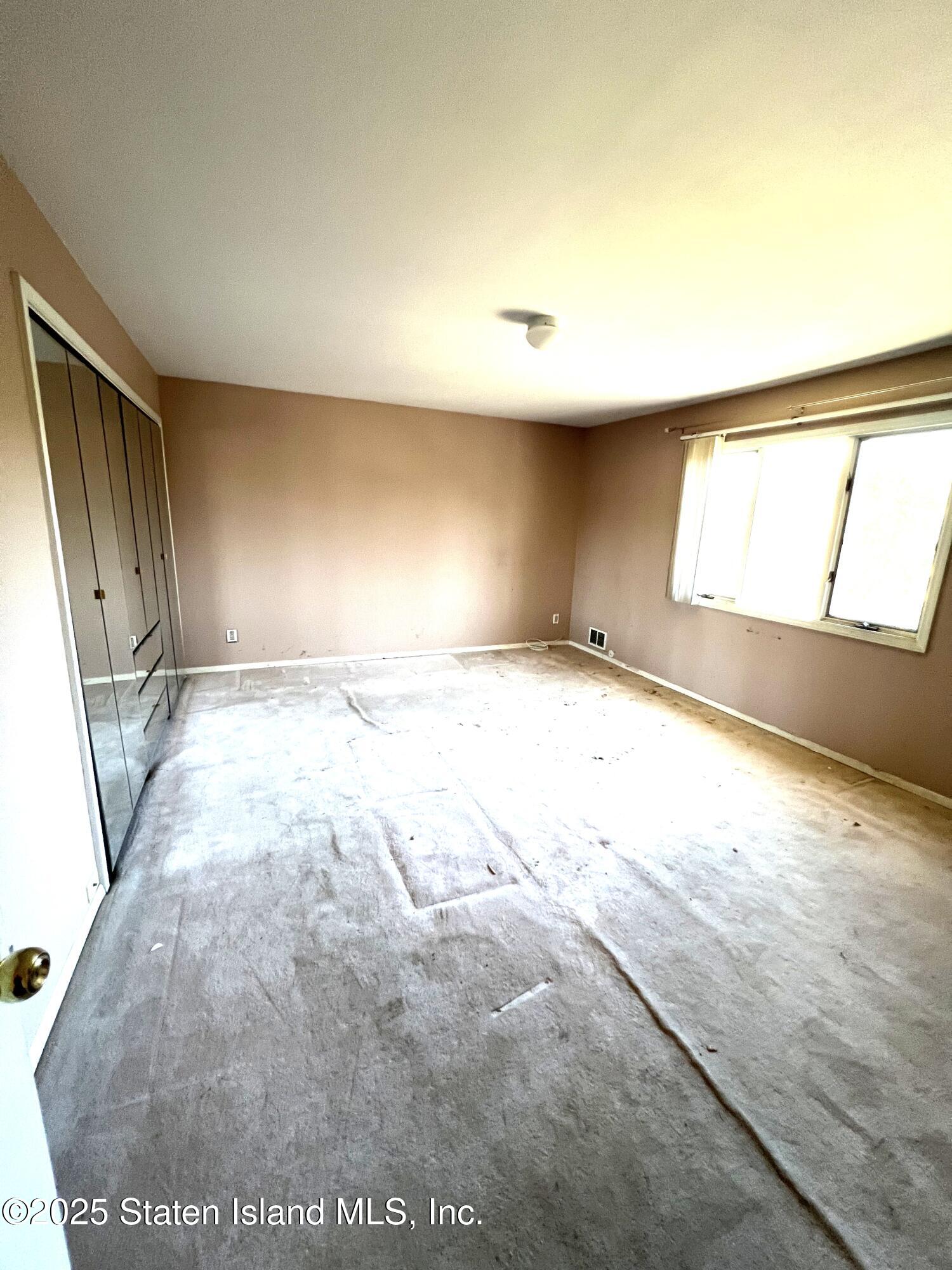 85 Foster Road Staten Island, NY 10309 - Photo 21 of 34 a view of an empty room and window