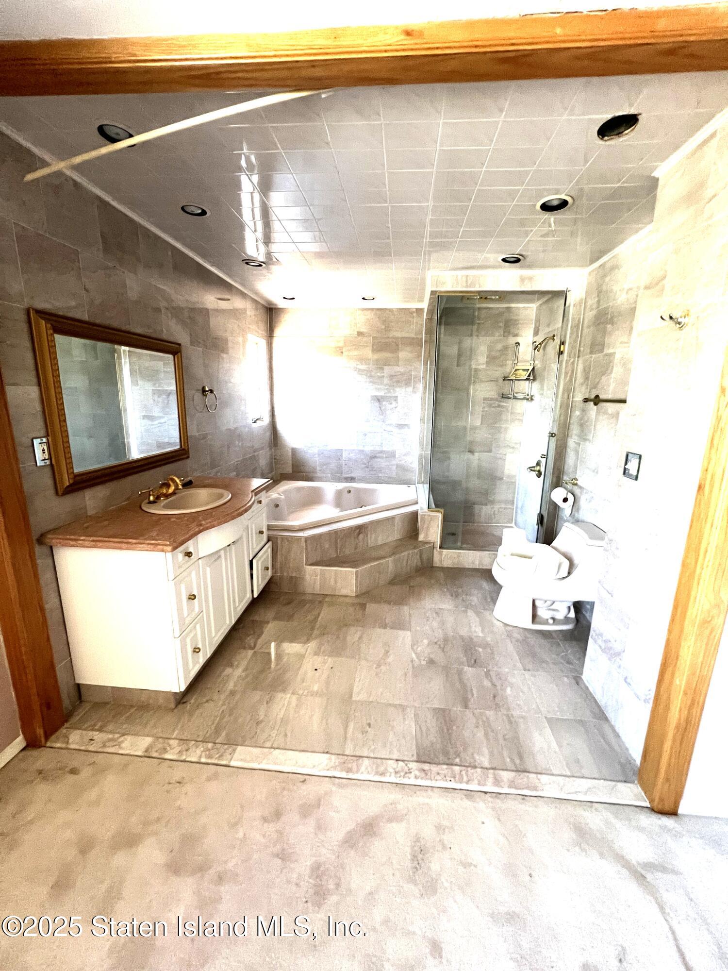 85 Foster Road Staten Island, NY 10309 - Photo 25 of 34 a living room with couches and kitchen view with wooden floor