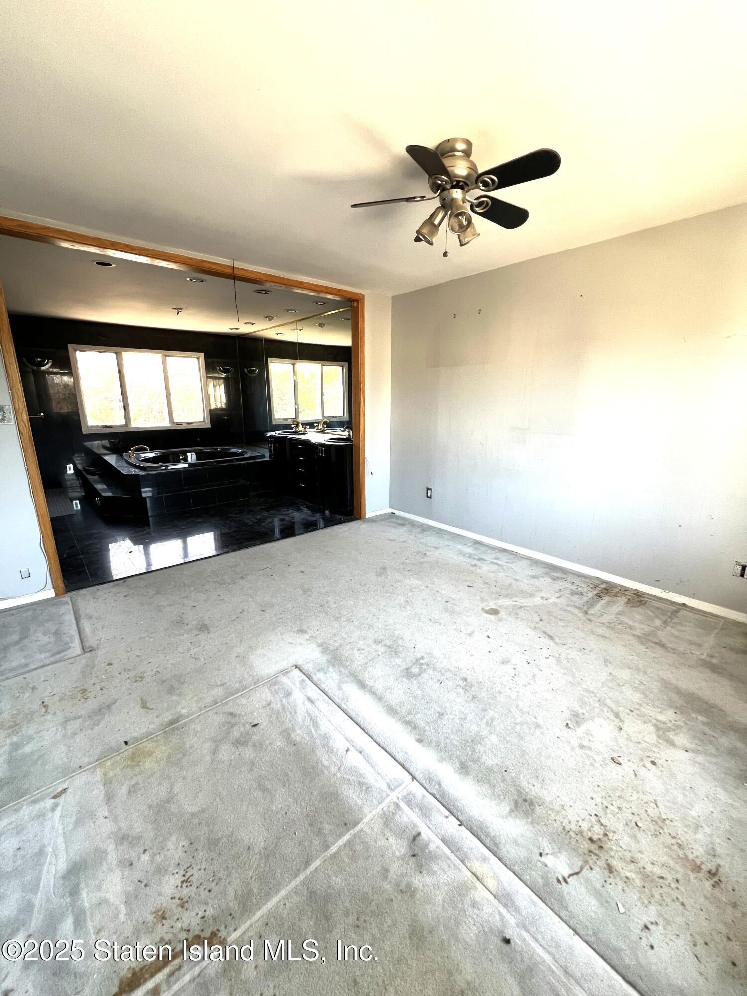85 Foster Road Staten Island, NY 10309 - Photo 27 of 34 a view of a livingroom with a ceiling fan and window