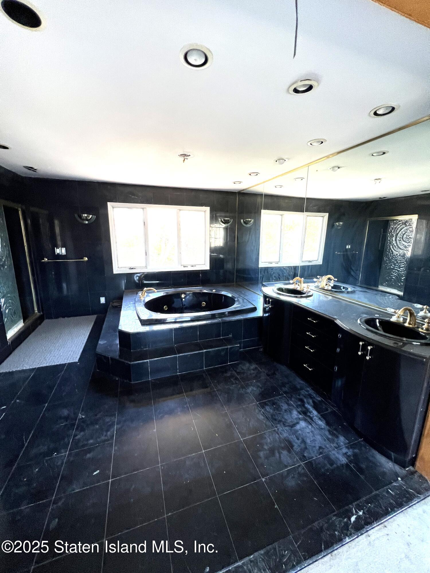 85 Foster Road Staten Island, NY 10309 - Photo 28 of 34 a kitchen with a stove a sink a counter space and cabinets