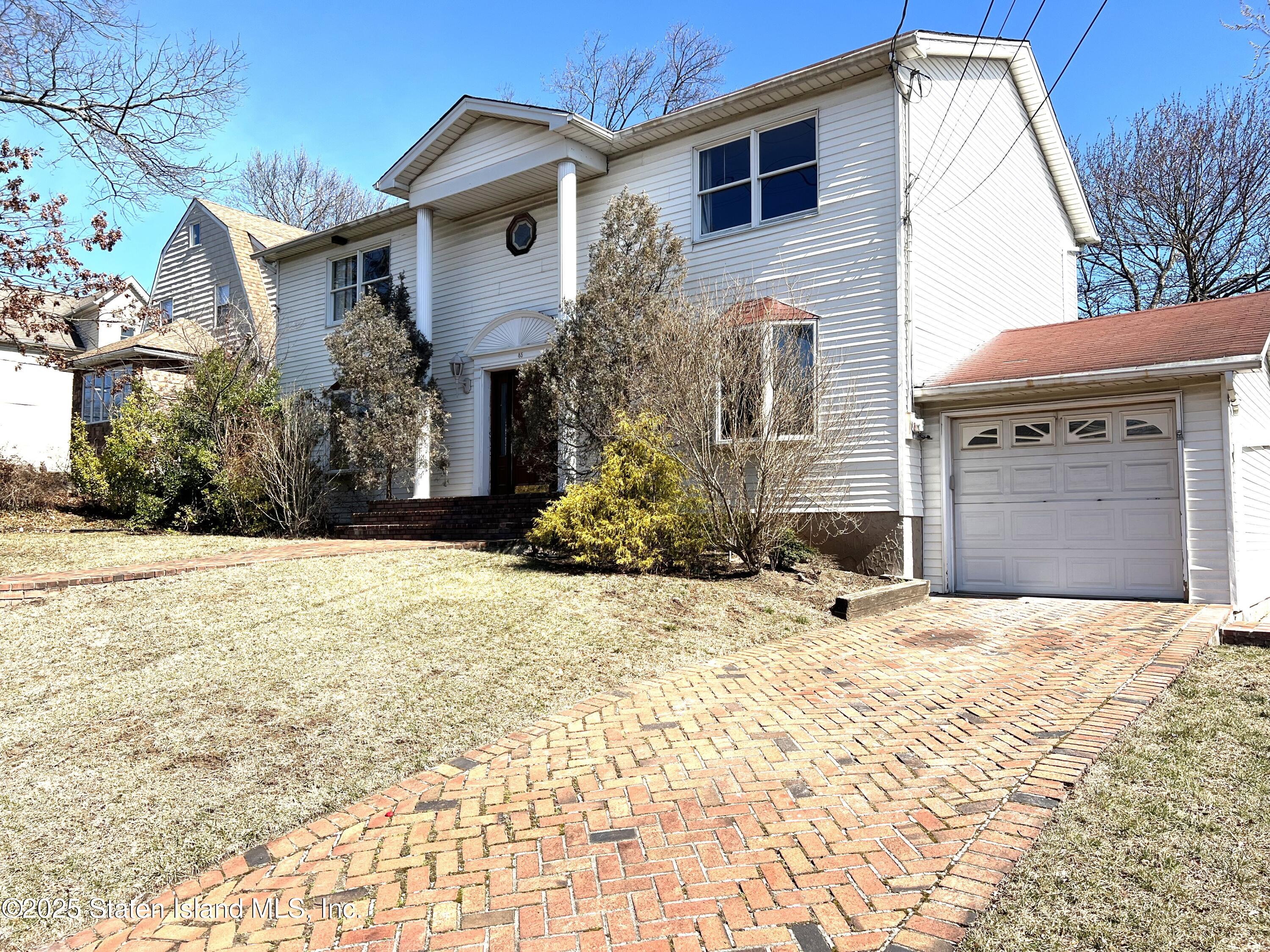 85 Foster Road Staten Island, NY 10309 - Photo 4 of 34 a front view of a house with a yard