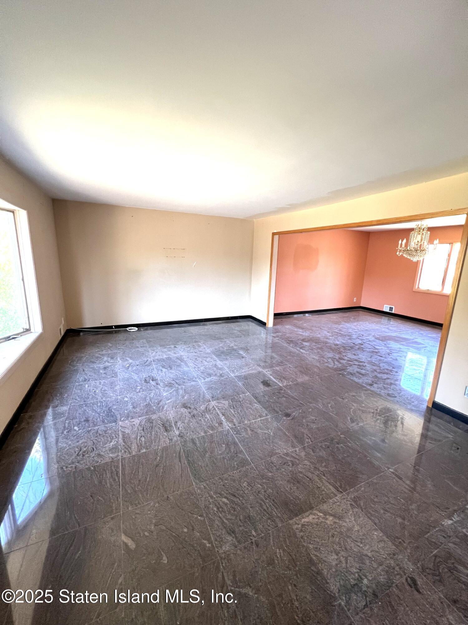 85 Foster Road Staten Island, NY 10309 - Photo 7 of 34 an empty room with wooden floor and windows