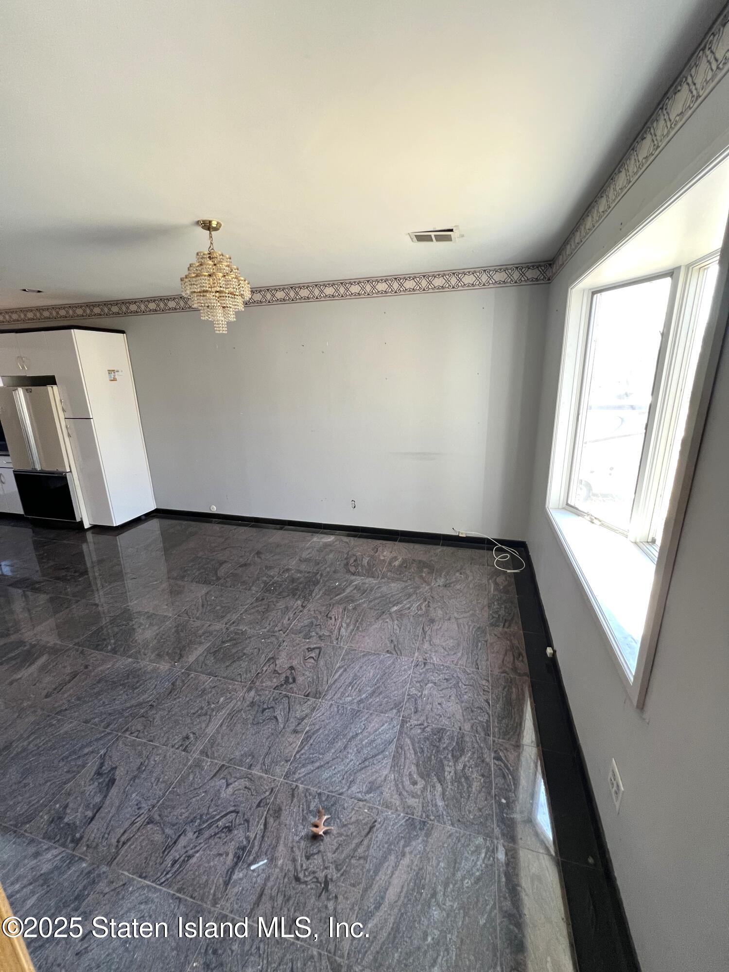 85 Foster Road Staten Island, NY 10309 - Photo 8 of 34 wooden floor in an empty room with a window