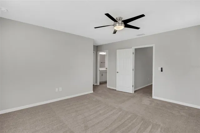 a view of a livingroom with a ceiling fan & a ceiling fan
