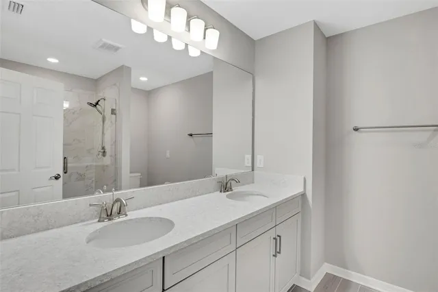 a bathroom with a sink double vanity and a mirror