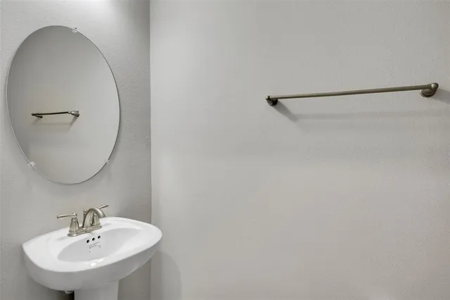 a bathroom with a sink a mirror and a shower