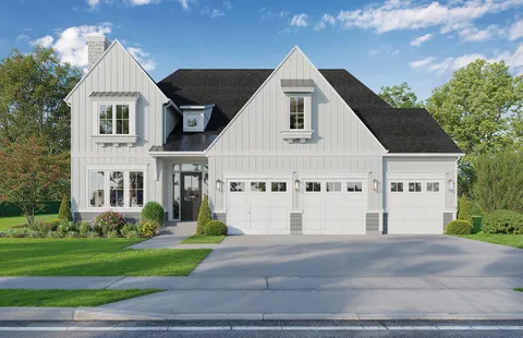 a view of a white house with a yard and table and chairs under an umbrella