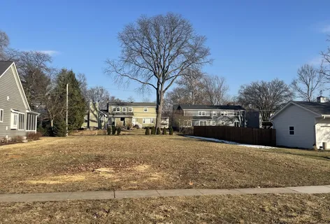 a view of a house with a yard covered in snow