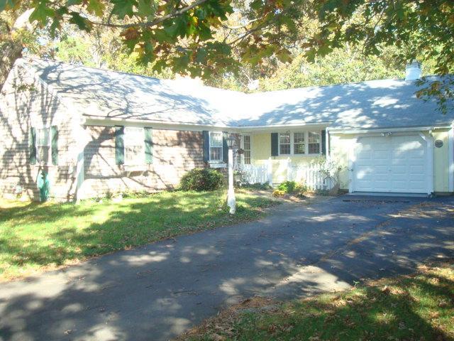 208 Bumps River Road Osterville, MA 02655 - Photo 1 of 16 a view of a yard in front of a house with large windows