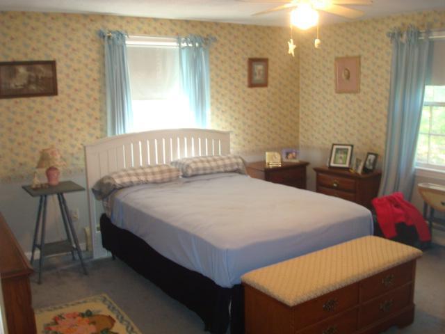 208 Bumps River Road Osterville, MA 02655 - Photo 11 of 16 a bedroom with a bed and a window