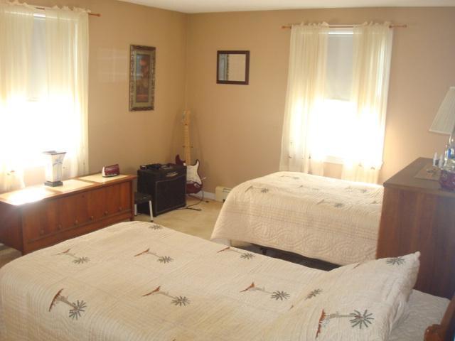 208 Bumps River Road Osterville, MA 02655 - Photo 13 of 16 a bedroom with a bed and a dresser