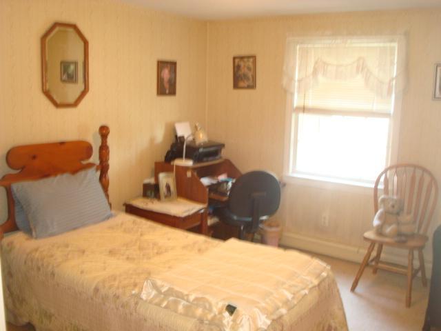 208 Bumps River Road Osterville, MA 02655 - Photo 14 of 16 a bedroom with a bed and chair with the floor