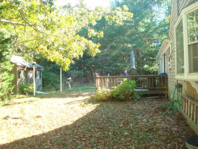 208 Bumps River Road Osterville, MA 02655 - Photo 3 of 16 a view of a backyard with plants