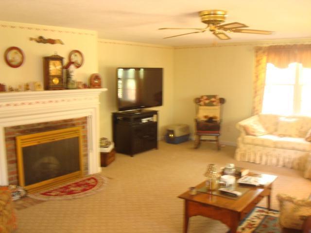 208 Bumps River Road Osterville, MA 02655 - Photo 4 of 16 a living room with fireplace furniture and a flat screen tv