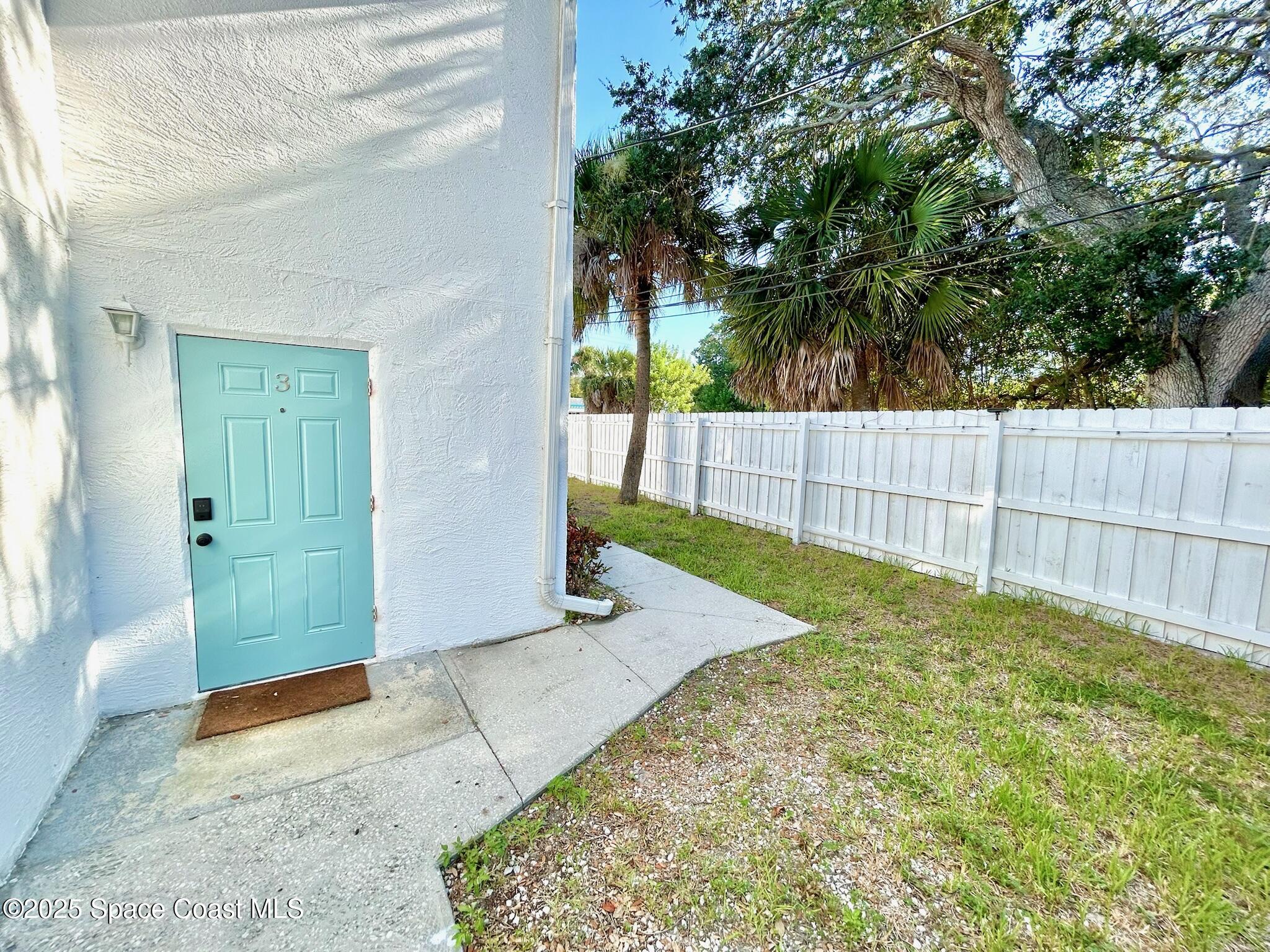 8110 Canaveral Boulevard, Unit 3 Cape Canaveral, FL 32920 - Photo 12 of 25 a view of backyard with green space