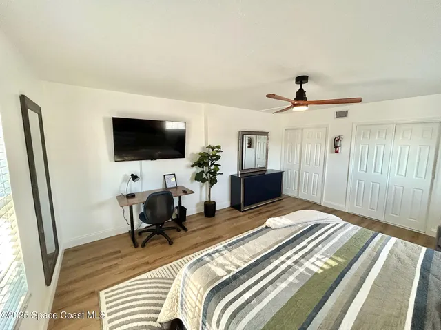 a bedroom with a bed and a potted plant