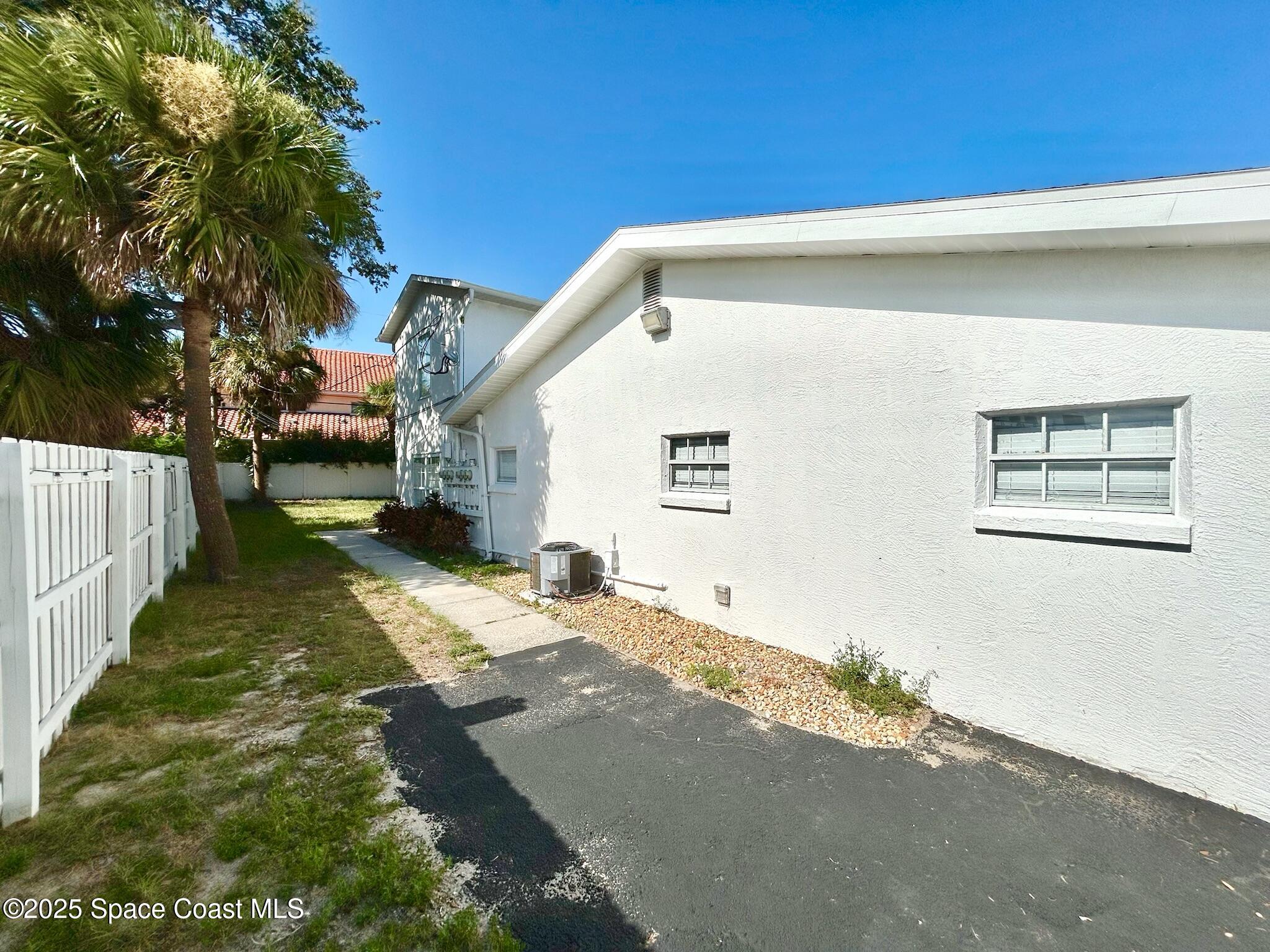 8110 Canaveral Boulevard, Unit 3 Cape Canaveral, FL 32920 - Photo 10 of 25 a view of a house with a backyard