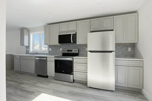 a kitchen with a refrigerator stove and microwave