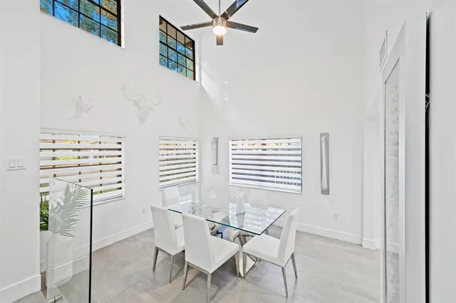 a view of a dining room with furniture and window