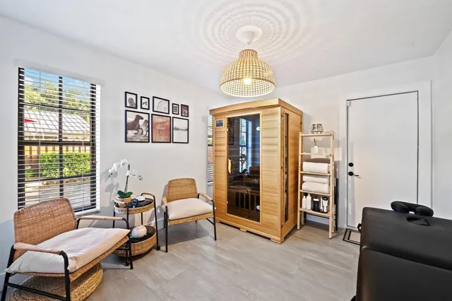 a living room with furniture a window and a chandelier