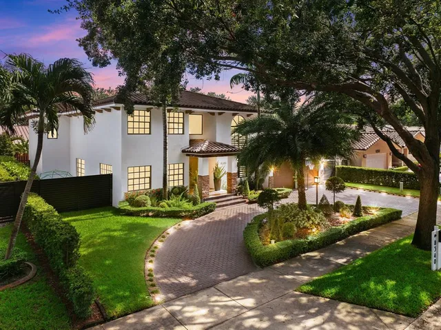 a front view of a house with garden and swimming area