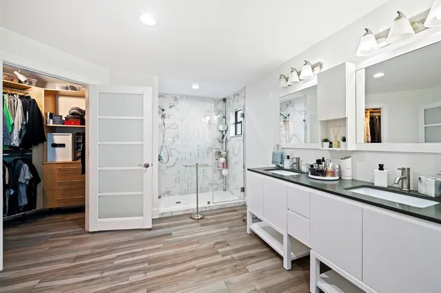 a view of a livingroom with furniture wooden floor and a large window