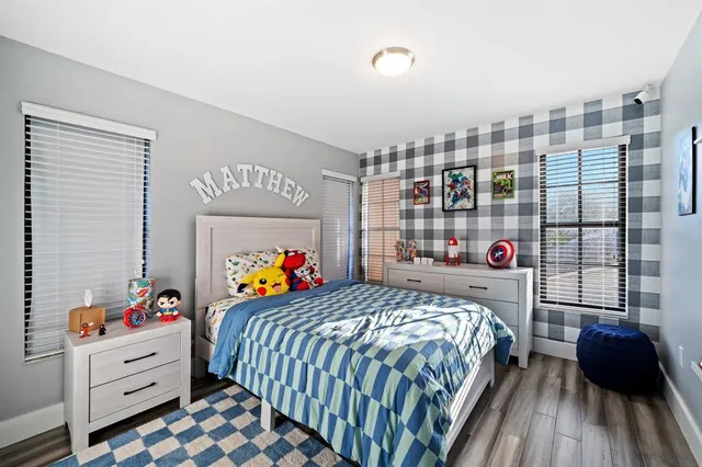 a bed room with two bed and a chair