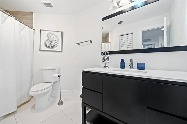 a view of a patio with couches table and chairs and potted plants