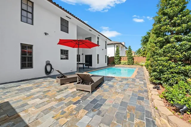 a view of a house with a yard and sitting area