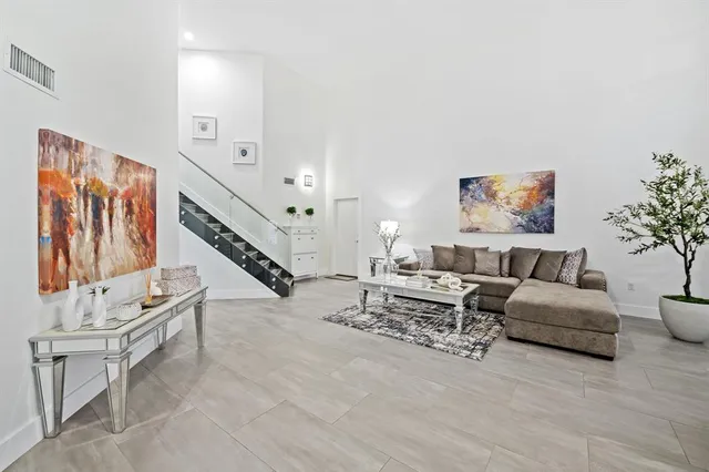 a living room with furniture and paintings on the wall