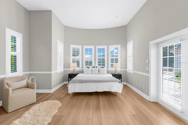 a dining room with furniture a chandelier and wooden floor
