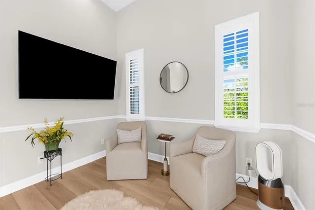 a kitchen with stainless steel appliances granite countertop a refrigerator a stove and a wooden cabinets with wooden floor