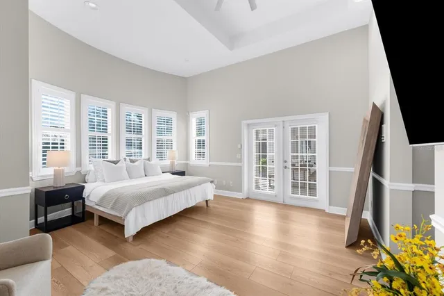 a kitchen with stainless steel appliances a dining table chairs and wooden floor