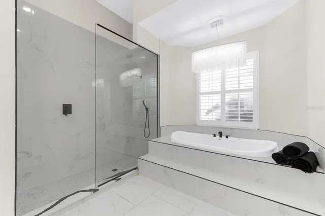 a large kitchen with stainless steel appliances kitchen island granite countertop a large island in the center