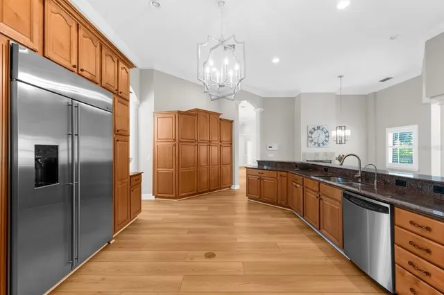 a bedroom with a bed and a wooden floor