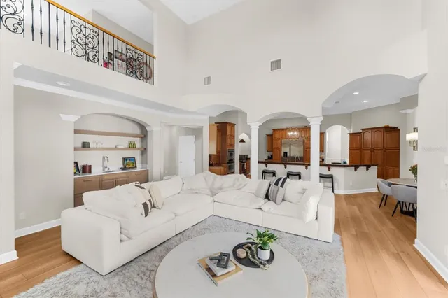 a view of a patio with couches table and chairs and potted plants