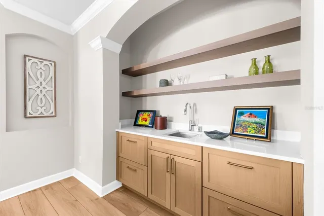 a view of a patio with chairs and table under an umbrella