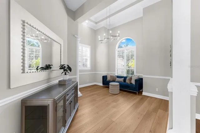 a view of a living room and kitchen with wooden floor