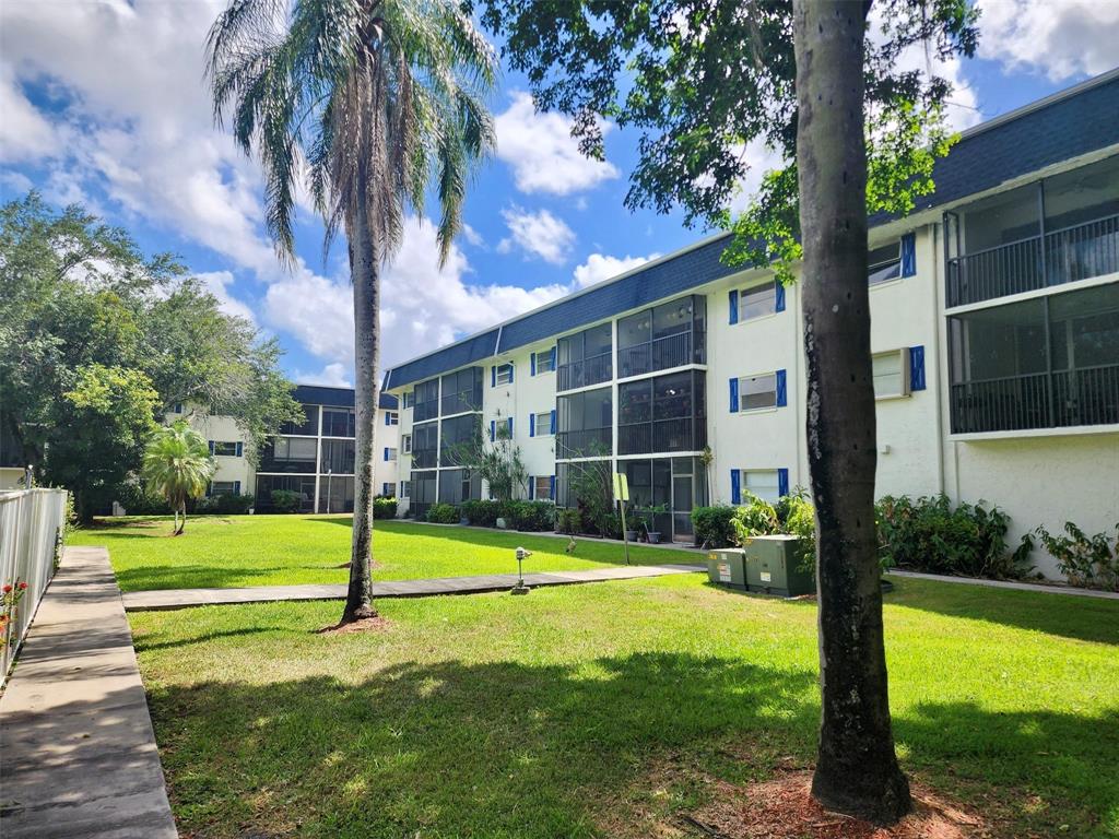 5090 Southwest 64th Avenue, Unit 204 Davie, FL 33314 - Photo 24 of 25 Tree lined walkways