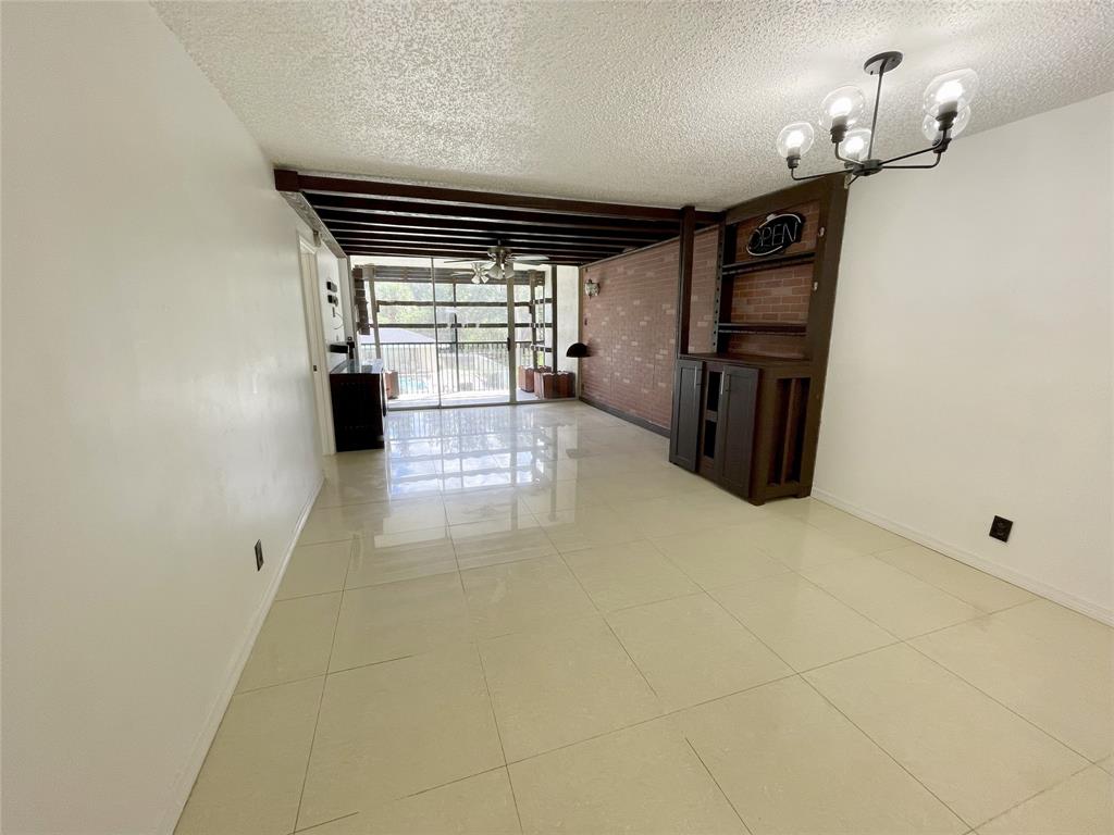 5090 Southwest 64th Avenue, Unit 204 Davie, FL 33314 - Photo 6 of 25 Charming wood beams line the ceiling in the living room